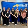 Dr. Derrick Hamilton, CEO and CMO of Juniper Health (Far Left) along with HCTC President Dr. Jennifer Lindon (Far Right) poses with 11 local students.